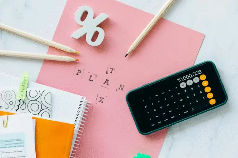 Sell my car uk planning concept with calculator, percentage sign, and stationery on a pink desk