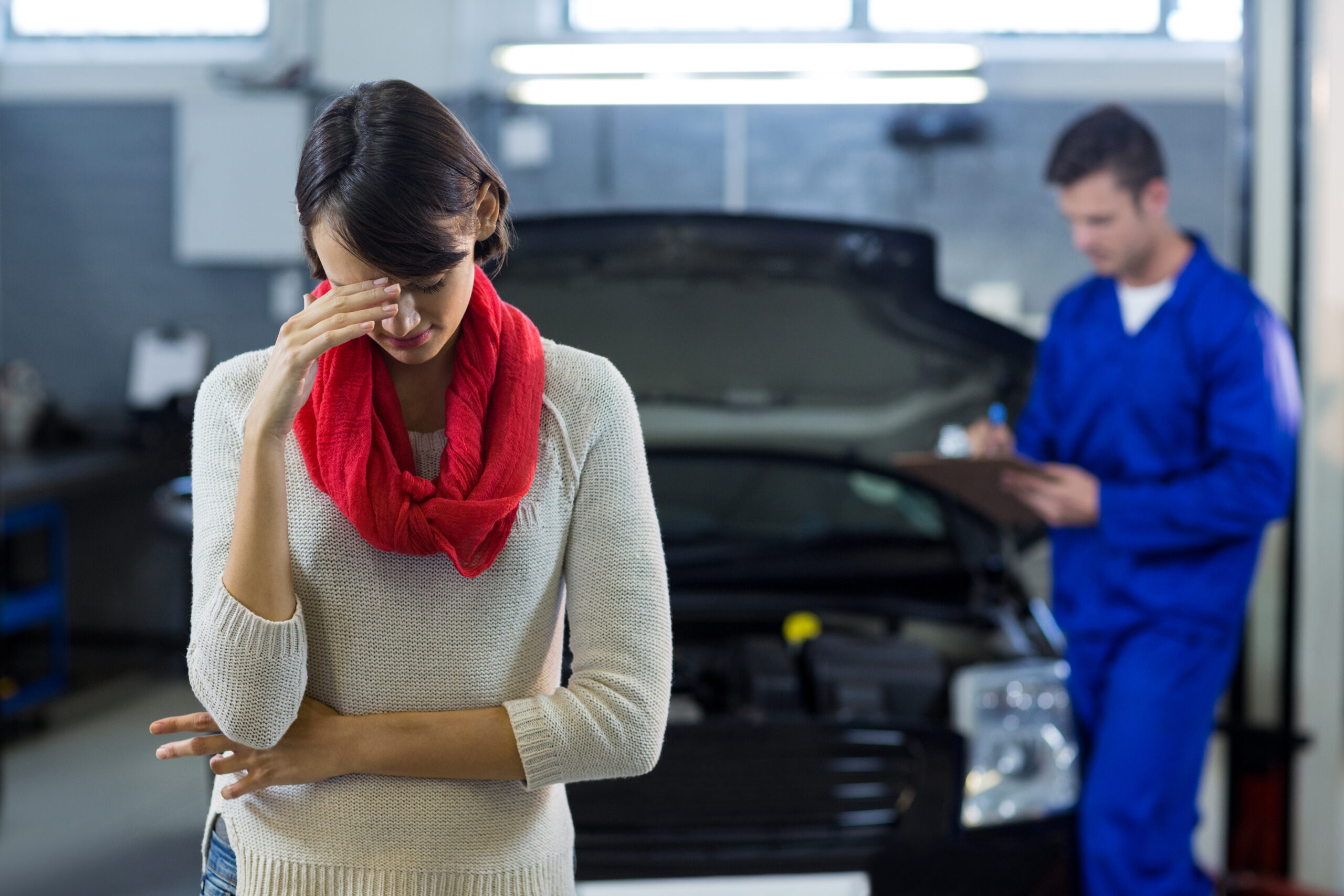 MOT Failure 2026 car repair cost stress woman at garage after vehicle fails MOT test